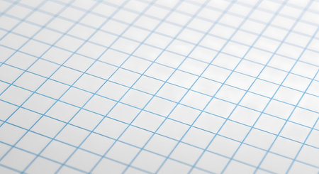 A macro, angled photograph of a sheet of white graph paper, showing the precise pattern of blue grid lines. The image is clean and minimalist, suitable for backgrounds related to mathematics, engineering, design, and education.の素材