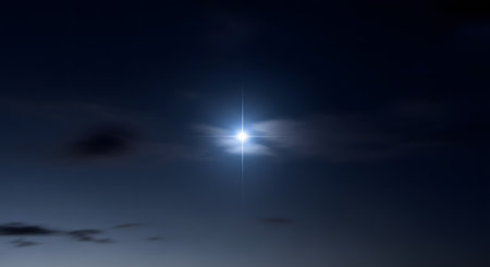 A single, brilliant bright star, possibly the North Star or a planet like Venus, shining with a cross-shaped lens flare in a dark blue night sky. Wispy, dark clouds are visible, adding to the serene and mystical atmosphere.の素材