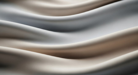 A soft-focus, abstract image of gentle, flowing waves in a smooth fabric of neutral colors like beige, cream, and grey. The minimalist and elegant composition creates a serene and luxurious background texture.の素材