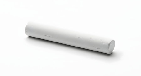 A single piece of thick, white cylindrical chalk lying on a plain white background. The studio shot emphasizes its simple texture and form.の素材