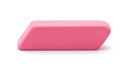 A single pink rubber eraser, shaped like a parallelogram, is shown isolated on a clean white background. The studio shot highlights the simple school or office supply object.の素材