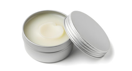 An open, round aluminum tin container showing the light-yellow cosmetic balm or wax inside, with the lid resting beside it. This product mockup is isolated on a white background, ideal for lip balm, body butter, or solid perfume.の素材