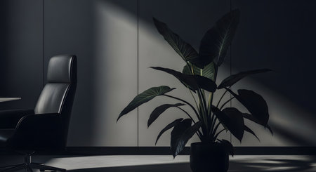 A modern and minimalist office interior with a moody, dark gray wall. A black leather executive chair and a large, green potted plant are illuminated by a shaft of light, creating dramatic shadows. This image represents elegance, corporate design, and a quiet, professional workspace.の素材