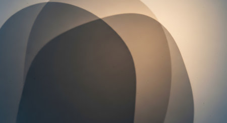 An abstract composition of soft, curved shadows cast against a textured beige surface. The interplay of light and dark creates a minimalist, geometric pattern with a calm and artistic aesthetic.の素材