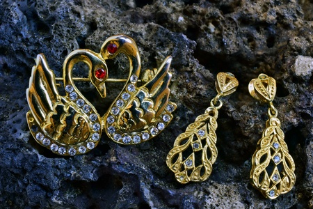 Earring and brooch on a stoneの素材