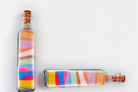 bottles full of colored sand forming designs for decoration and adornmentの写真素材