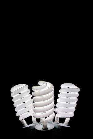 three spiral light bulbs on black backgroundの写真素材