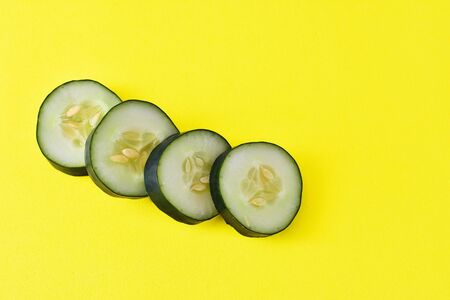 sliced cucumber of spain on yellow background