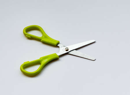 Green scool scissor isolated on white backgroundの写真素材