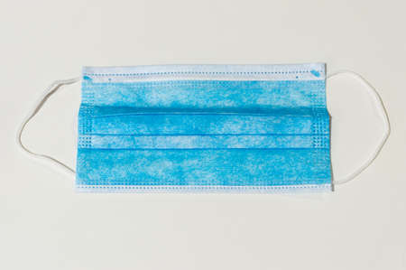 protecting disposable medical mask to protect yourself against coronavirus on white background