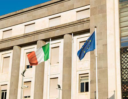 European Union EU and Italian Flags Together waving at wind outside a buildingの写真素材