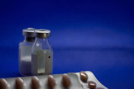 Vaccine bottles with pills close up