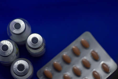 Vaccine bottles with pills high view
