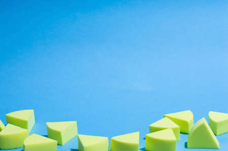 Make-up yellow sponges on a blue background - empty copy space areaの写真素材
