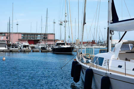 Side view boats in a pier, city mediterranean sea in a sunny day with blue sky,