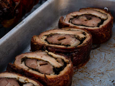 sliced roast pork roll in a metal tray. Rustic Roast Pork Recipeの写真素材