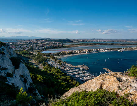 aerial view of the coast of the city of Cagliari, Sardinia Italy, and the piers with moored boatsの写真素材