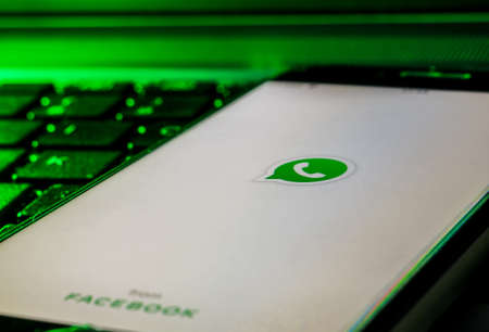 Cagliari, Sardinia, Italy - 30 10 2021 - Mobile phone smartphone on a computer keyboard with the Whatsapp app logo on starting screenのeditorial素材