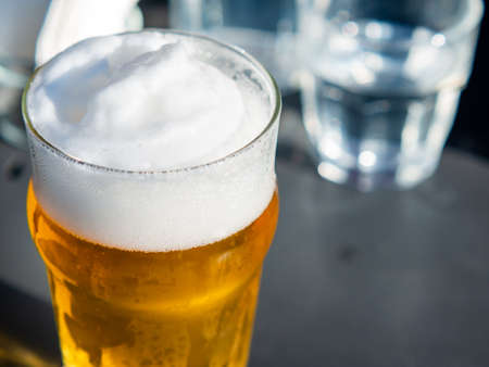 close up mug of lager beer with high froth