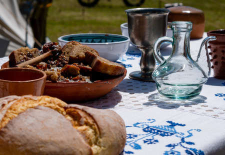 medieval historical reenactment - assortment various musical instruments such as flutes, trumpets and a lute on a musician artist's tableの写真素材