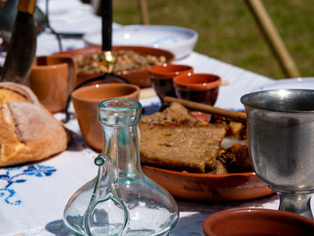 medieval reenactment - table set for outdoor medieval dining in a park during a festivalの写真素材