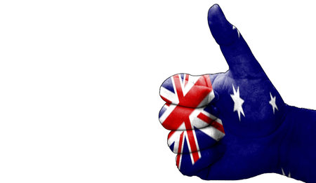 hand with thumbs up in approval with the Australian flag painted. Image with empty white background copy space areaの写真素材