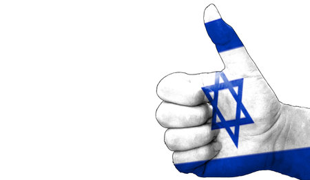hand with thumbs up in approval with the Israeli flag painted. Image with empty white background copy space areaの写真素材