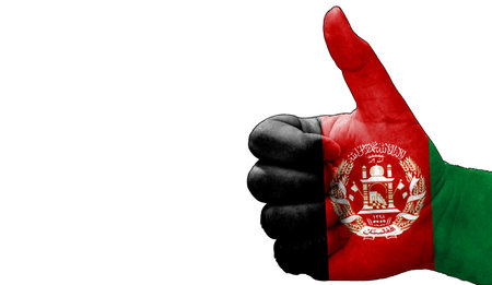 thumbs up in approval with the Afghan flag paintedの写真素材