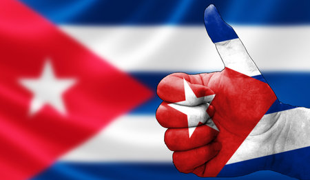 thumbs up in approval with the Cuban flag painted,の写真素材