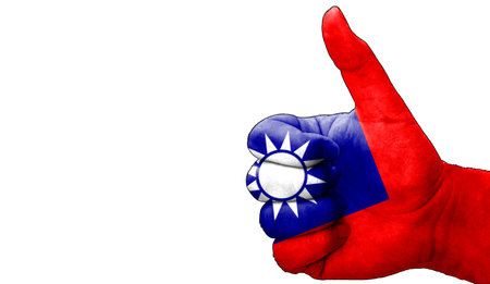 hand with thumbs up in approval with the Taiwanese flag painted. Image with empty white background copy space areaの写真素材