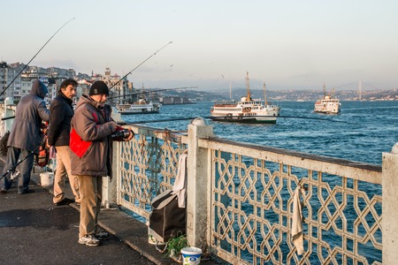 ISTAMBUL, TURKEY - APRIL, 18: Fishermen on the Galata bridge on 11 april 2013のeditorial素材