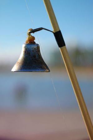 Detail of a Bell on a Fishing Rod by the Oceanの写真素材