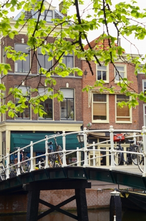 A Typical Scene From The Netherlands Of Bikes On A Brodge Over A Canalの写真素材