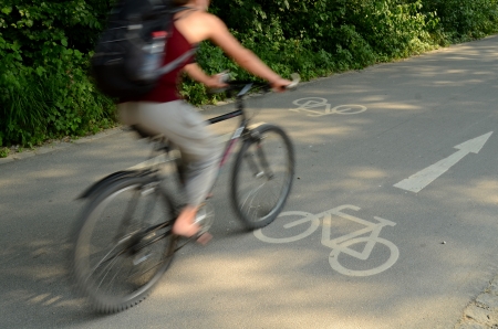 Motion Blur Of A Cyclist On A Cycle Lane On A Sunny Dayの写真素材