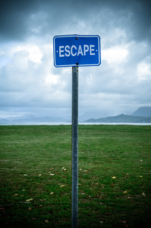 Conceptual Image Of A Grungy Escape Sign In An Empty Wildernessの写真素材