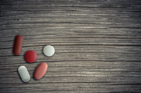 Healthcare Image Of Assorted Pills On A Wooden Tableの写真素材