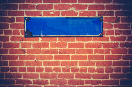 A Blank Blue Sign For Your Text On A Red Brick Wallの写真素材
