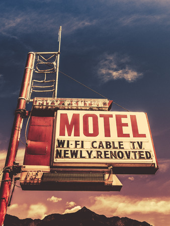 Retro Vintage Image Of Old Motel Sign In Small Town USA In The Mountainsの写真素材