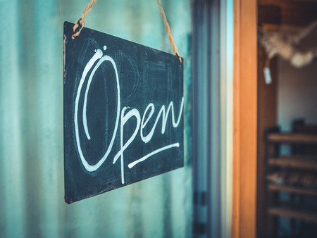 Rustic Open Sign Hanging In The Door Of A Coffee And Gift Shop In The Pacific Northwestの写真素材