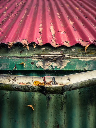 Broken Plastic Gutter On The Roof Of A House Or Farm Buildingの写真素材