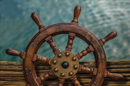 Nautical Detail Of A Ship's Wheel Against Tropical Ocean Waterの写真素材