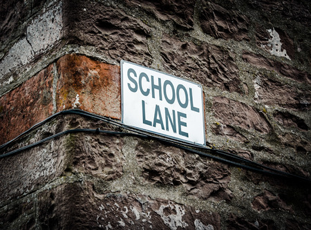 A Sign With School Lane On The Side Of A Building In The UKの写真素材