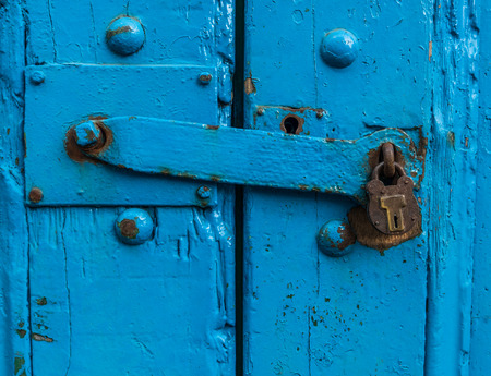 Vintage Sturdy Blue Wooden Door With Heavy Metal Lockの写真素材