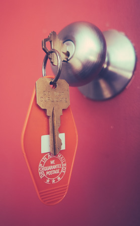 Vacation Detail Of A Retro Motel Room Key In The Door Handleの写真素材