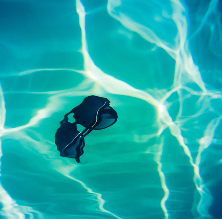 Retro Style Image Of Sunglasses Falling Into A Swimming Poolの写真素材
