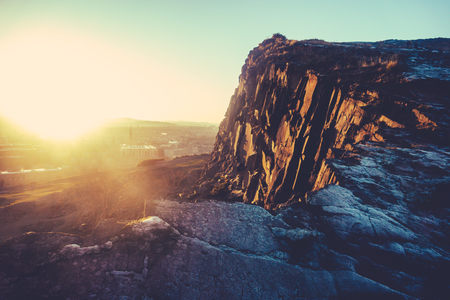 Low Winter Sun Over Edinburgh, Scotland, With Salisbury Crags In The Foregroundの写真素材