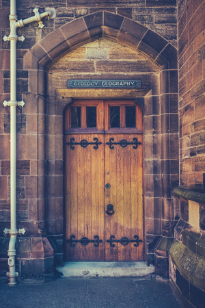 An Old Wooden Door At A College Of A Prestigious University Or Schoolの写真素材