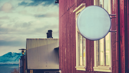 A Blank Sign Outside A Business In Reykjavik, Iceland, With Snowy Mountains In The Distanceの写真素材