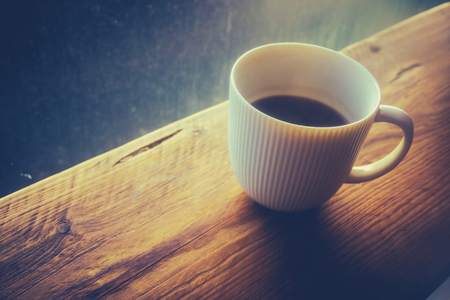 Retro Filtered Cup Of Hot Black Coffee In A Hipster Cafeの写真素材