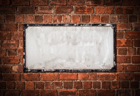 Grungy Old Blank White British Street Sign on a Red Brick Wallの写真素材